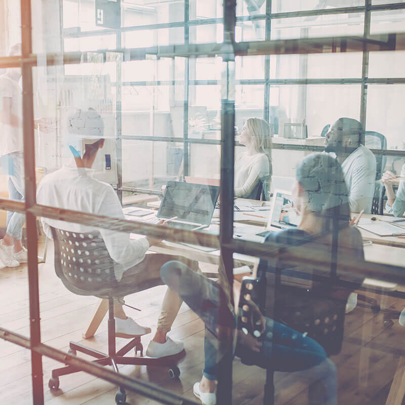 People around a meeting table in a small office